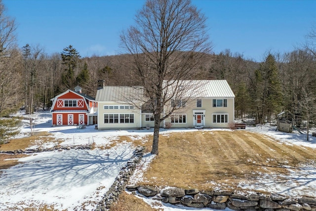 444 Tin Shanty Rd, Shrewsbury, VT 05738 - snow covered back of property featuring an outdoor structure and a wooded view
