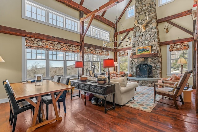 444 Tin Shanty Rd, Shrewsbury, VT 05738 - living room featuring hardwood / wood-style floors, a fireplace, beamed ceiling, and a wealth of natural light