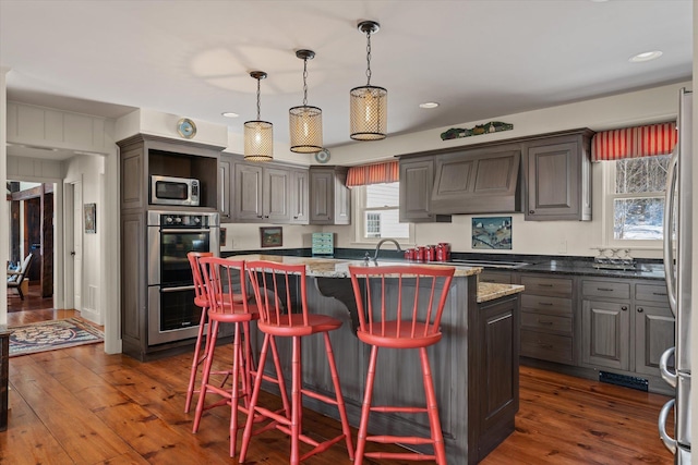 444 Tin Shanty Rd, Shrewsbury, VT 05738 - kitchen featuring dark wood-style flooring, appliances with stainless steel finishes, an island with sink, and custom exhaust hood