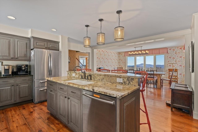 444 Tin Shanty Rd, Shrewsbury, VT 05738 - kitchen featuring wood-type flooring, a breakfast bar area, a sink, and appliances with stainless steel finishes