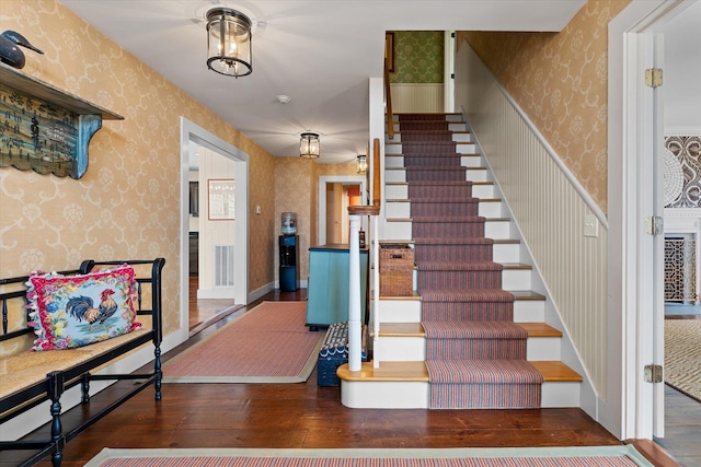 444 Tin Shanty Rd, Shrewsbury, VT 05738 - stairway with wallpapered walls, hardwood / wood-style flooring, baseboards, and visible vents