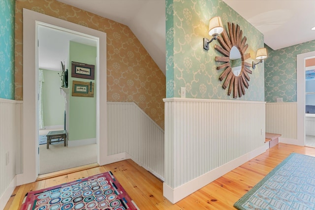 444 Tin Shanty Rd, Shrewsbury, VT 05738 - hall with wood-type flooring, wallpapered walls, a wainscoted wall, and vaulted ceiling