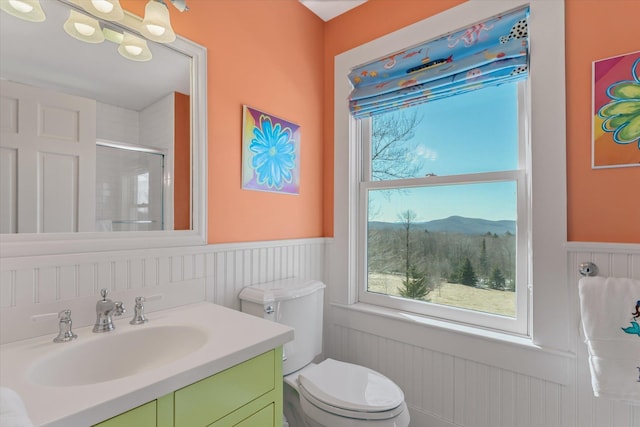 444 Tin Shanty Rd, Shrewsbury, VT 05738 - bathroom with a shower stall, toilet, vanity, a mountain view, and wainscoting
