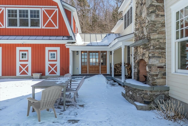 444 Tin Shanty Rd, Shrewsbury, VT 05738 - snow covered property entrance featuring stone siding, metal roof, a standing seam roof, and board and batten siding