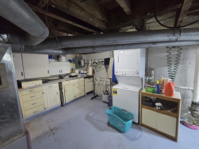 unfinished below grade area featuring electric panel and stacked washer / dryer