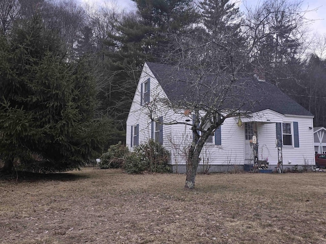 view of front facade featuring a shingled roof and entry steps