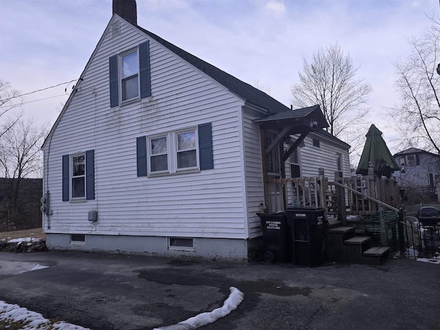 view of side of home featuring a chimney