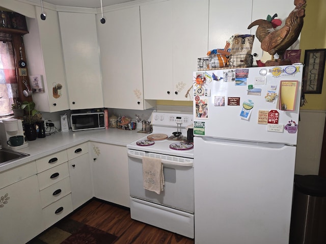 kitchen with white appliances, light countertops, dark wood-type flooring, and white cabinets