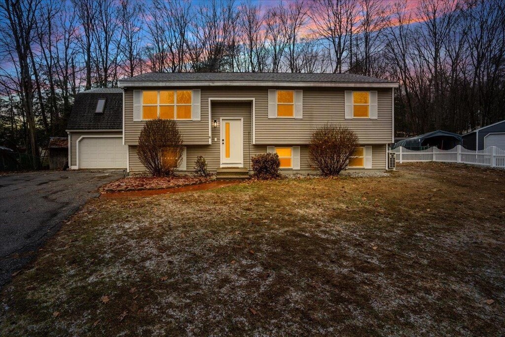 8 Columbine Pl, Concord, NH 03303 - raised ranch with driveway, fence, and a front lawn