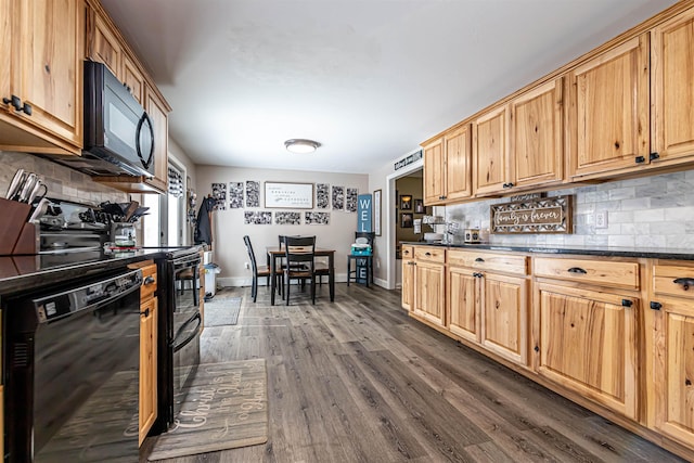 kitchen with tasteful backsplash, baseboards, dark countertops, dark wood-style floors, and black appliances