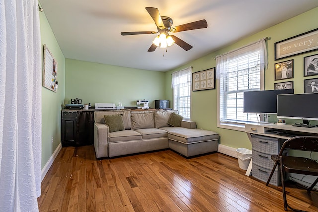 office space featuring hardwood / wood-style floors, ceiling fan, and baseboards