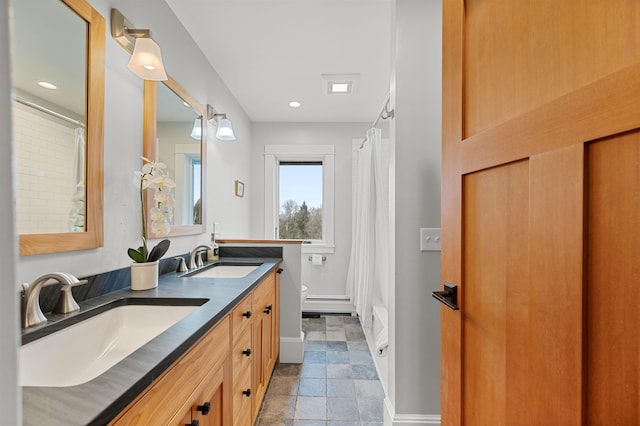 437 Lonesome Trl, Waterbury, VT 05676 - bathroom featuring toilet, a sink, baseboards, and baseboard heating
