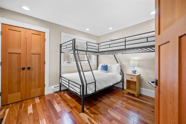 437 Lonesome Trl, Waterbury, VT 05676 - bedroom featuring a baseboard radiator, hardwood / wood-style flooring, baseboards, and recessed lighting