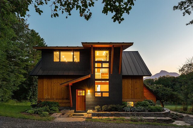 437 Lonesome Trl, Waterbury, VT 05676 - view of front of home with board and batten siding, a standing seam roof, and metal roof