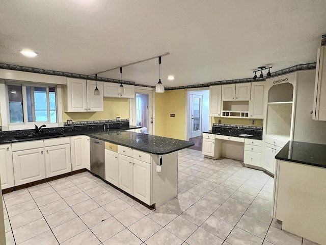 kitchen with a sink, dishwasher, a peninsula, light tile patterned floors, and white cabinets