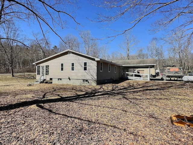 view of property exterior with an attached carport and entry steps