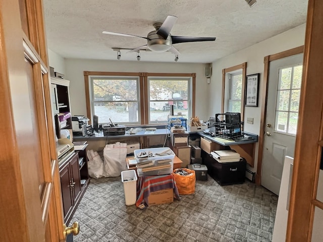 office space with a ceiling fan and a textured ceiling