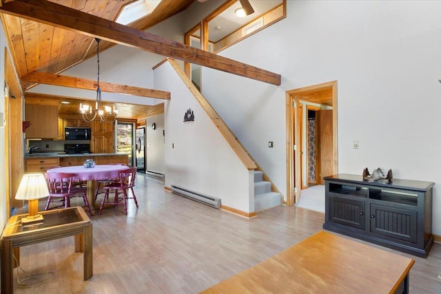 living area featuring light wood-style floors, beamed ceiling, baseboard heating, stairs, and a notable chandelier