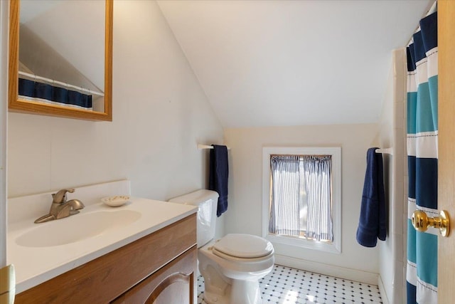 bathroom featuring toilet, vanity, a shower with shower curtain, and lofted ceiling