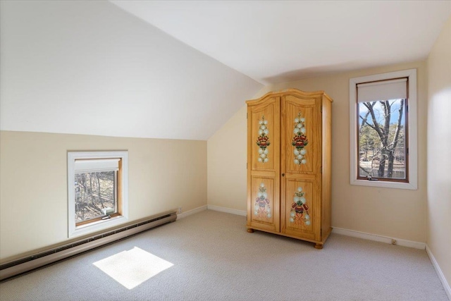 bonus room with light colored carpet, a baseboard heating unit, baseboards, and lofted ceiling