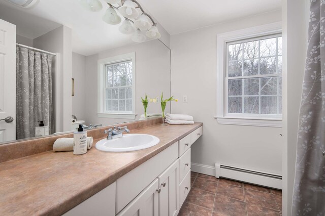 72 Natures Way, Wells, ME 04090 - full bath featuring a baseboard heating unit, vanity, baseboards, and tile patterned floors