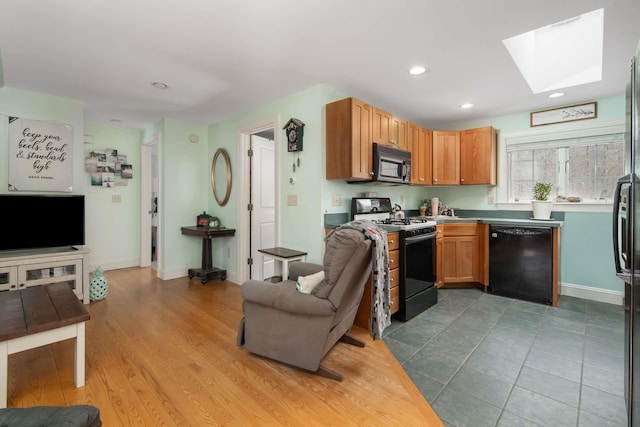 72 Natures Way, Wells, ME 04090 - kitchen with black appliances, baseboards, a skylight, and recessed lighting