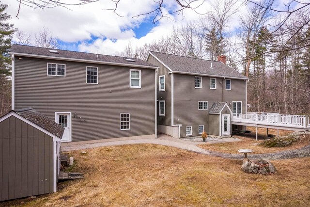 72 Natures Way, Wells, ME 04090 - rear view of property featuring a storage unit, a deck, and an outbuilding