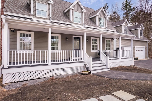72 Natures Way, Wells, ME 04090 - new england style home with a porch, driveway, a shingled roof, and a garage