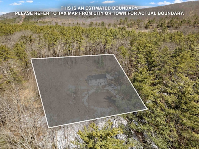 birds eye view of property with a view of trees