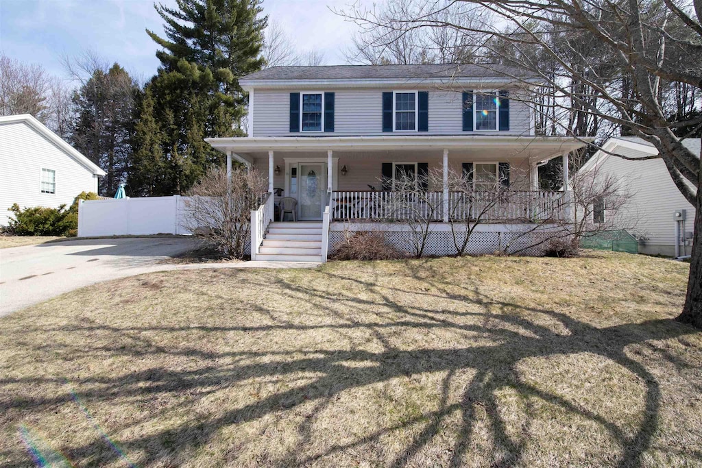 8 Bentwood St, Concord, NH 03303 - view of front facade featuring covered porch, a front yard, and fence