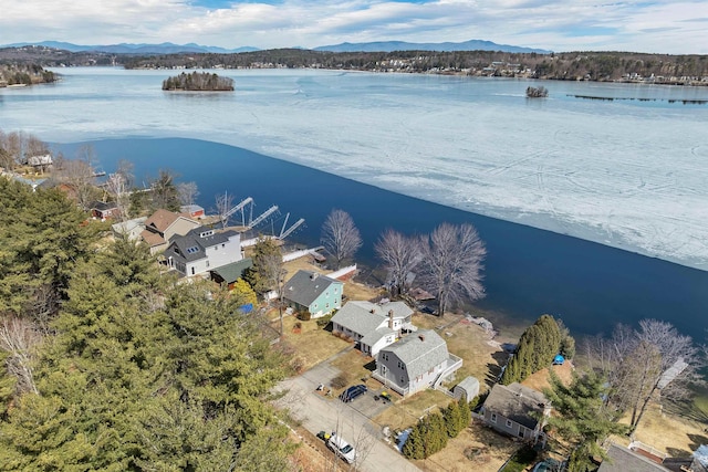 drone / aerial view featuring a water and mountain view and a residential view