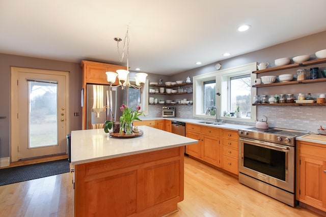 14 Adams Landing Rd, Grand Isle, VT 05458 - kitchen featuring open shelves, stainless steel appliances, a sink, light wood finished floors, and a notable chandelier