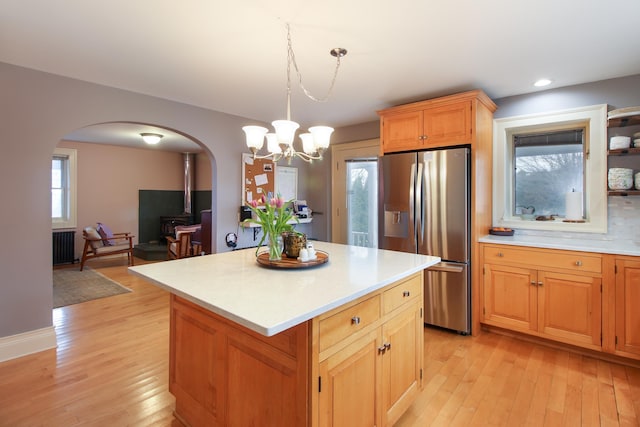 14 Adams Landing Rd, Grand Isle, VT 05458 - kitchen featuring light countertops, stainless steel fridge, light wood finished floors, arched walkways, and a center island