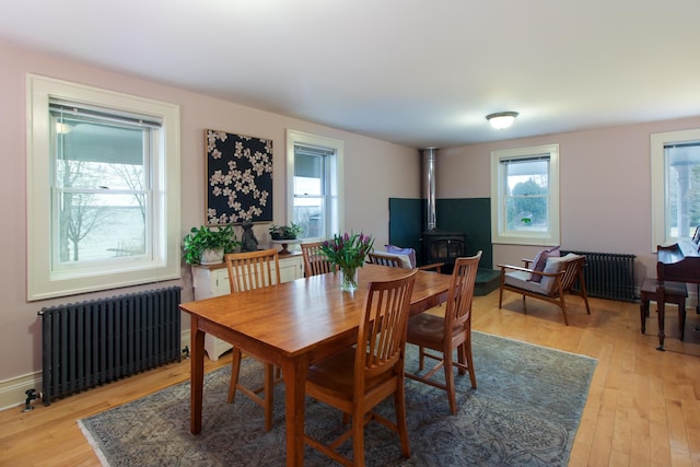 14 Adams Landing Rd, Grand Isle, VT 05458 - dining area featuring radiator, a wood stove, and a wealth of natural light