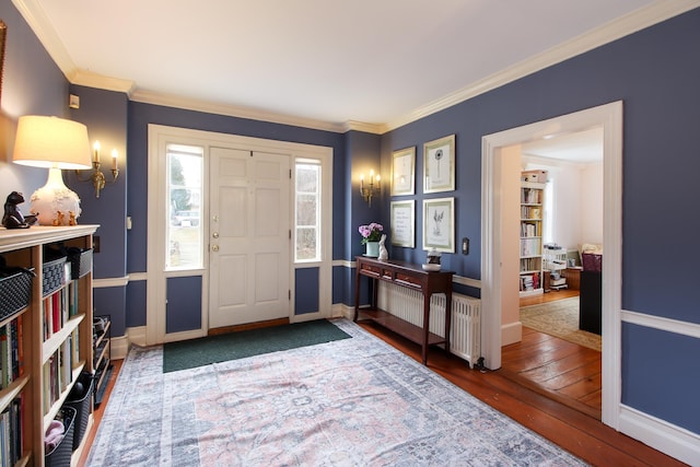 14 Adams Landing Rd, Grand Isle, VT 05458 - foyer entrance with baseboards, ornamental molding, radiator heating unit, and hardwood / wood-style flooring