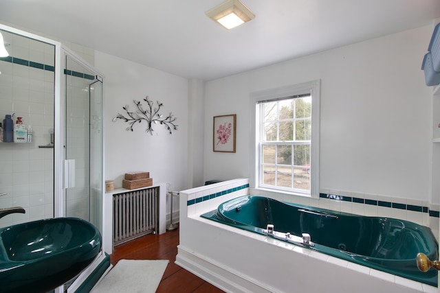 14 Adams Landing Rd, Grand Isle, VT 05458 - bathroom featuring radiator, a whirlpool tub, a shower stall, a sink, and wood finished floors