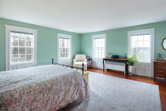 14 Adams Landing Rd, Grand Isle, VT 05458 - bedroom with a decorative wall, wood finished floors, and radiator heating unit