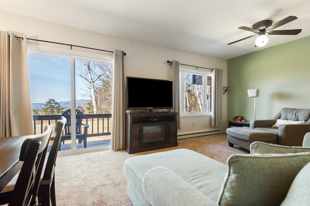 34 Weetamoo Trl Unit 5, Campton, NH 03223 - carpeted living room featuring a baseboard heating unit and ceiling fan