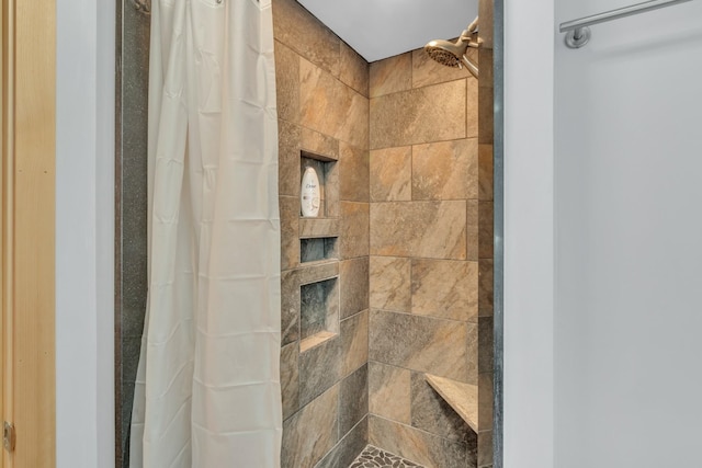 bathroom with a tile shower