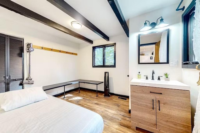 18 Crow Ln, Conway, NH 03818 - bedroom with beamed ceiling, light wood-style flooring, and baseboards