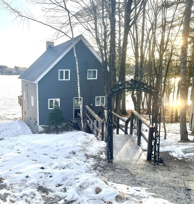 18 Crow Ln, Conway, NH 03818 - view of snowy exterior with a chimney