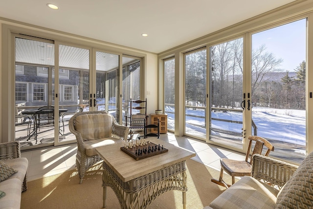sunroom with french doors, tile patterned flooring, and a healthy amount of sunlight
