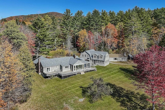 bird's eye view with a wooded view