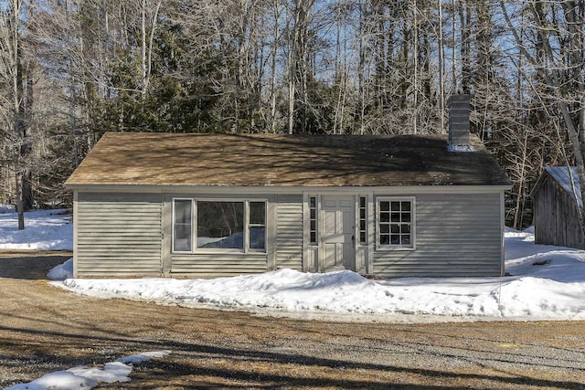 view of front of house featuring a chimney