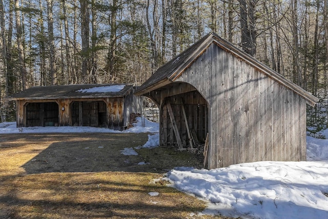 snow covered structure featuring an outdoor structure