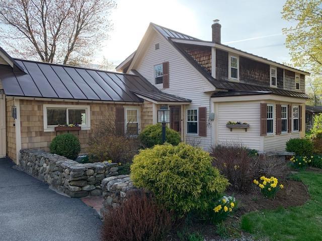 1747 River Rd, Weare, NH 03281 - view of property exterior featuring metal roof, a chimney, and a standing seam roof