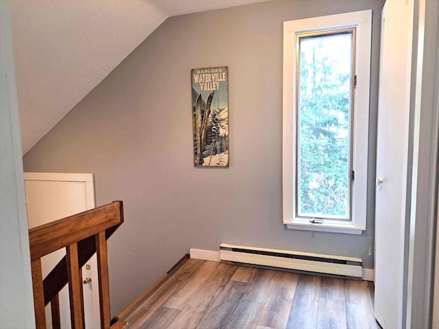 bonus room featuring baseboards, a baseboard radiator, wood finished floors, and lofted ceiling