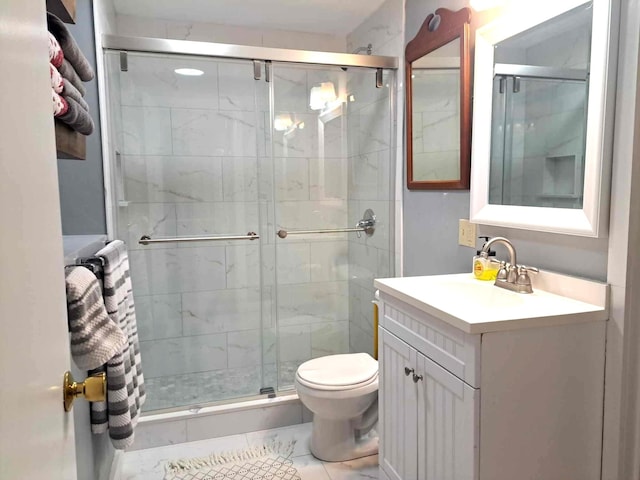 bathroom with a shower stall, vanity, and toilet