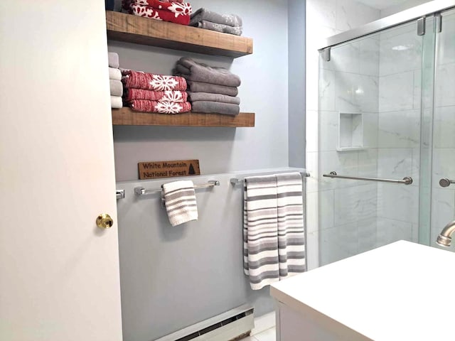 bathroom with a shower stall and a baseboard radiator