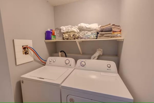 laundry room with separate washer and dryer and laundry area